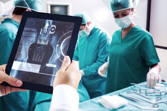 Man using tablet pc against medical interface on xray - ARTES ISAAC